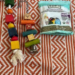 A Couple Of Bird Toys And A Bag Of Pellets (Bird Not Included He Was Just Looking Cute)
