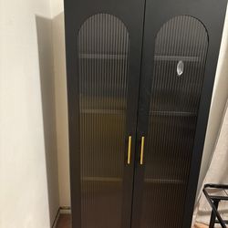 Tall metal cabinet and wooden dresser cabinet