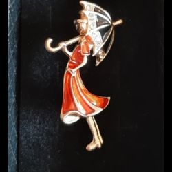 Brooch with a girl holding an umbrella