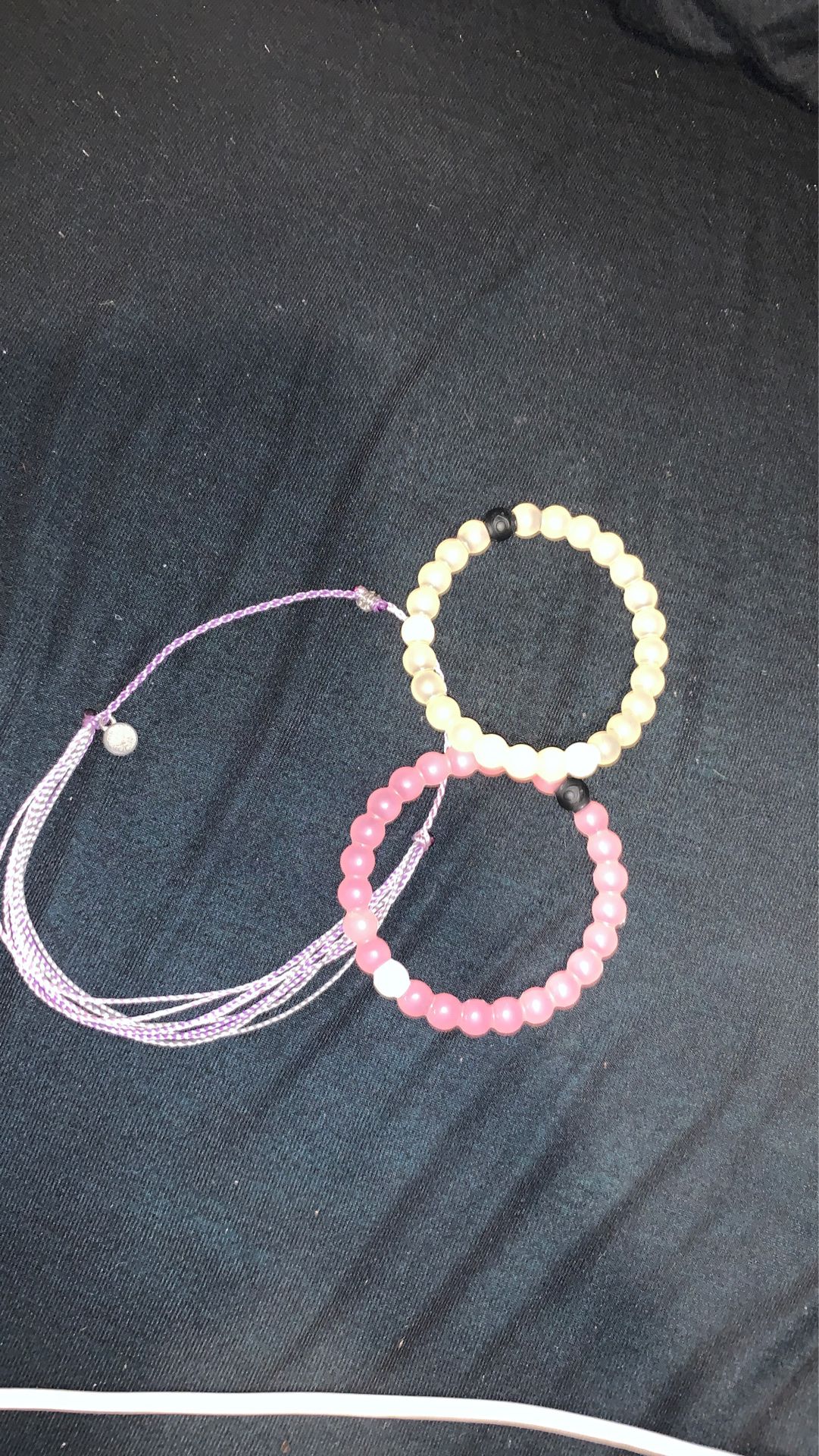 2 lokai and 1 pura vida bracelet
