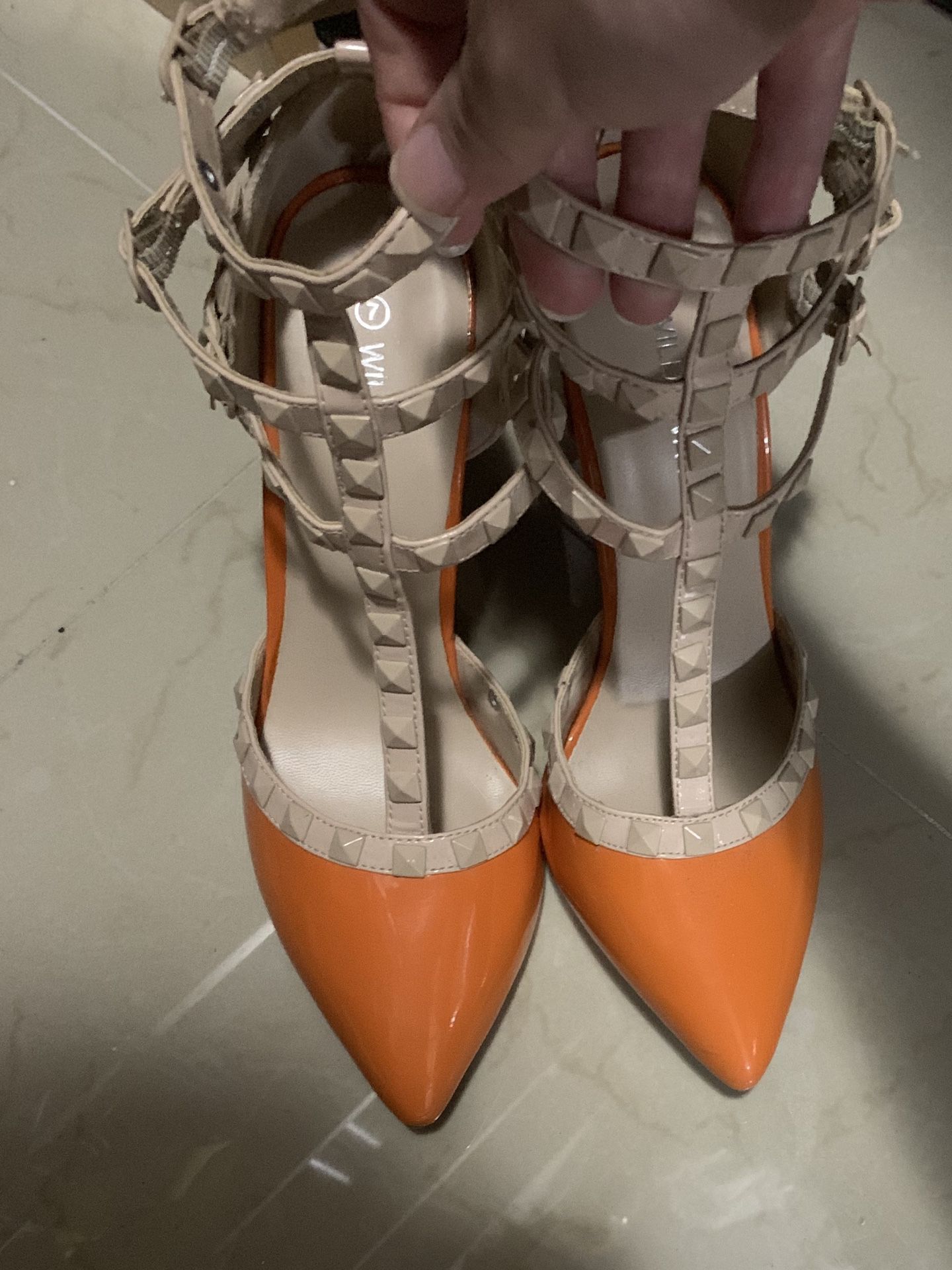 Orange studded strappy high heels