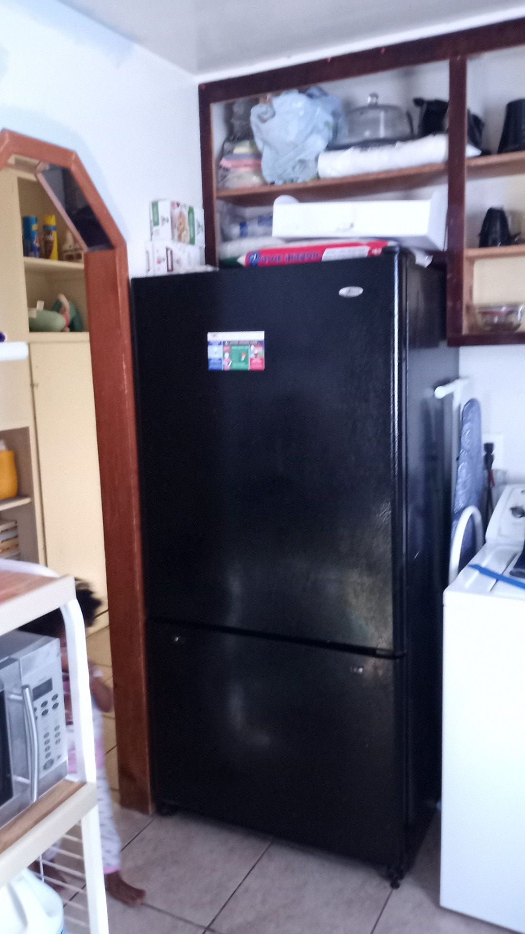 All black fridge with freezer on bottom. Not apt size