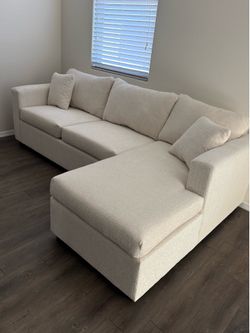 Brand new light cream sectionals with free ottoman (brand new in stock )