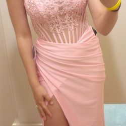 A strapless, long corset dress in a shade of pink.