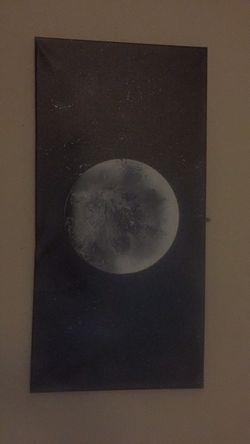 Spray painted moon on canvass