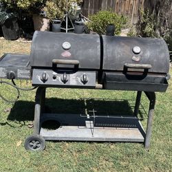BBQ Grill - Large Heavy Duty, Propane, Charcoal or Wood Griller on Wheels by CharGriller. In Fair Condition and Includes an Empty Propane Cylinder.