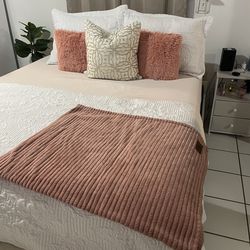 Queen bed,tree ornament ,table and two chairs .