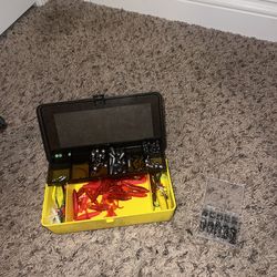 Fishing tackle lot with waterproof backpack, lures, hooks, and tackle box.