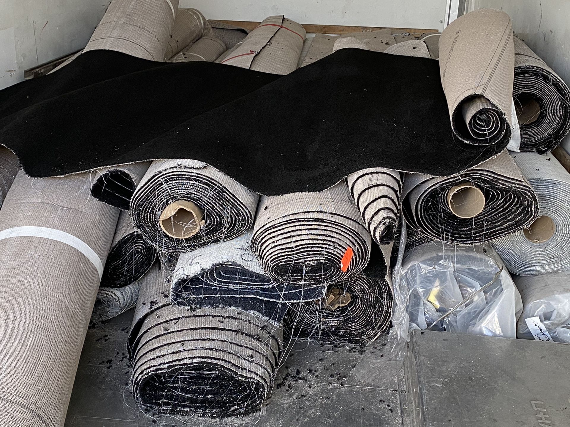 A variety of rolls of high quality carpet from $100 to $300 per roll