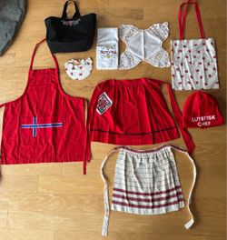 Norwegian goodies: 1 long apron, 2 short aprons, towel, visor, lace cloth, Lutefisk chef hat,canvas bag w/embroidery,cloth bag.