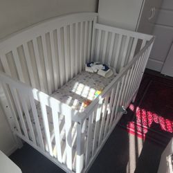 white baby crib with mattress
