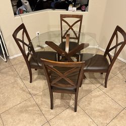 Glass top dining table with four chairs