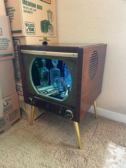 Custom repurposed vintage TV wet bar with decanters