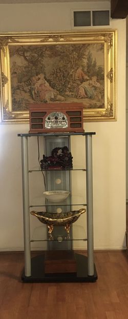 entertainment center with 3 thick glass shelves , wood top, aluminum legs and back . very solid.