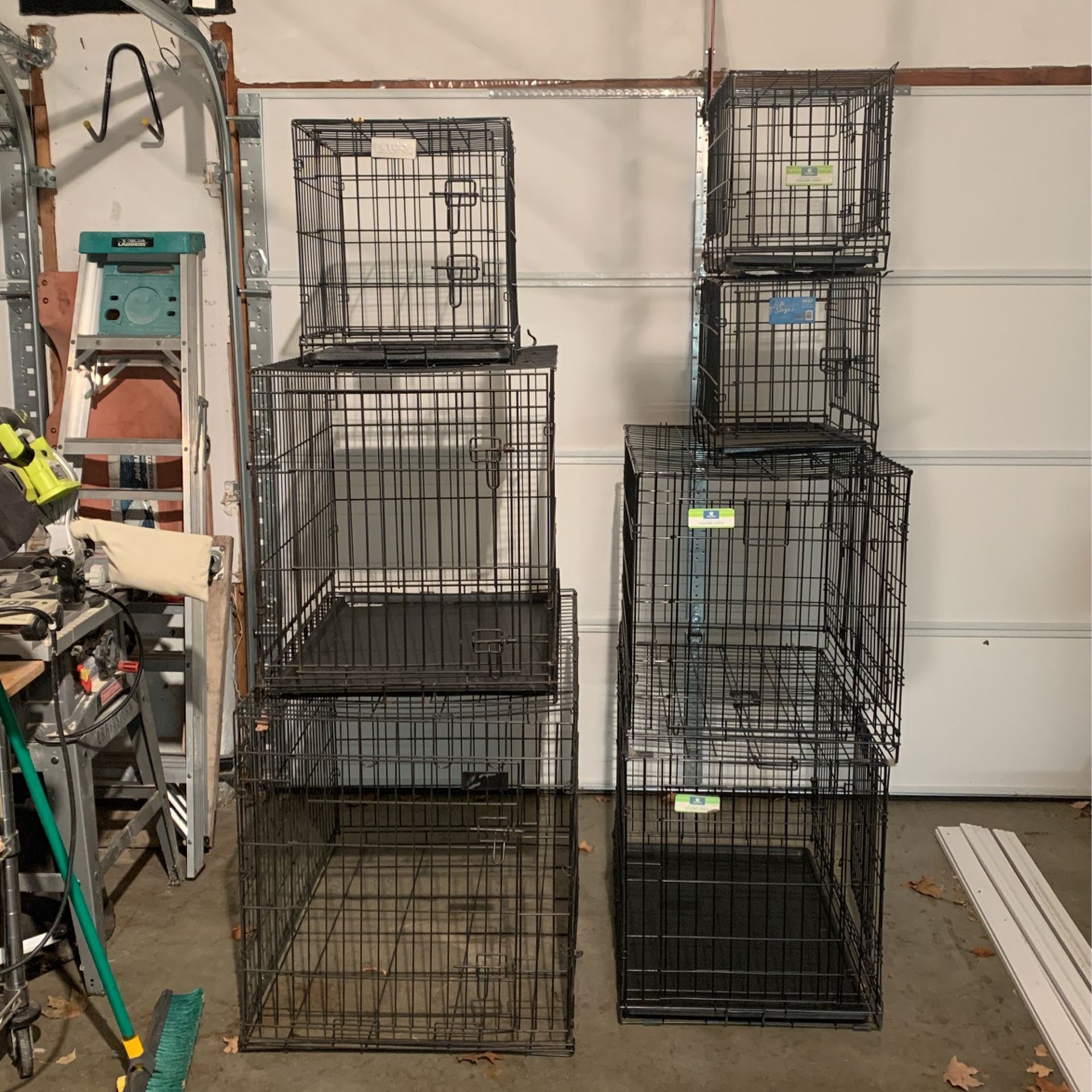 Seven folding dog crates