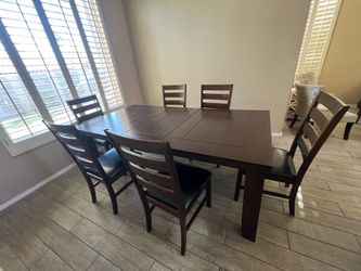 Large wood sturdy table.  With 6 chairs.