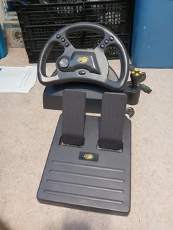 Mad Catz steering wheel/pedal set for Ps2 or N64. Works great!