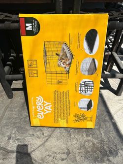 New dog crate medium size asking $60 thanks