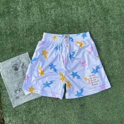 White Eric Emanuel shorts sith pink, blue and yellow stars size medium (brand new)
