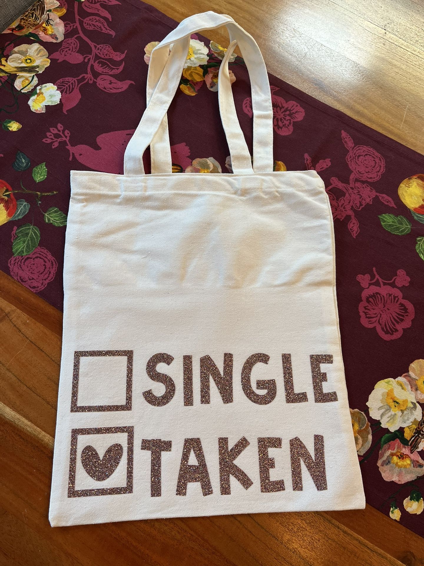 Stylish white tote bag featuring a playful 'Single Taken' print. Perfect for casual outings and daily use. Valentine’s love sparkles and glitter. Hand