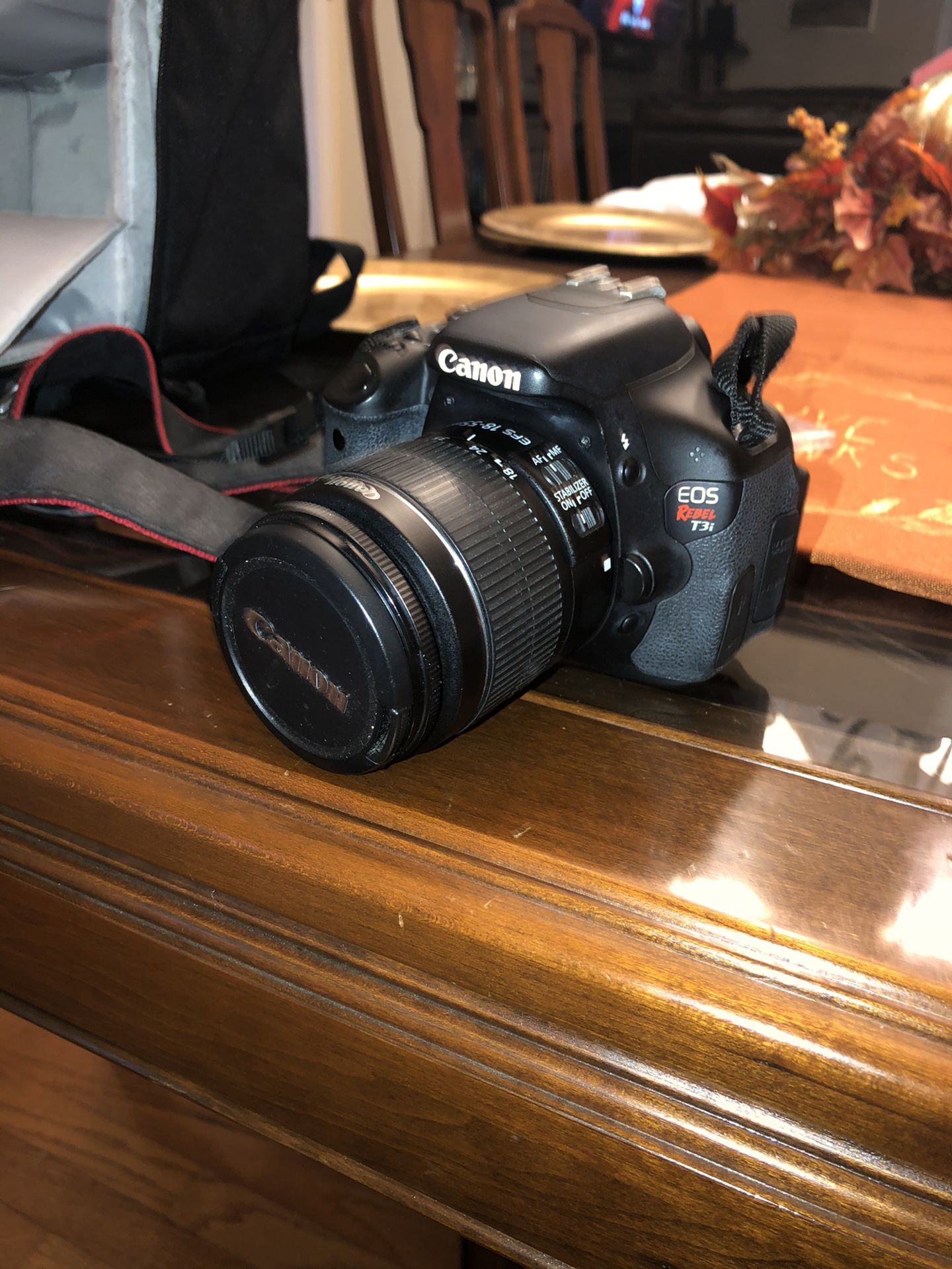 Canon EOS Rebel T3i DSLR camera with backpack
