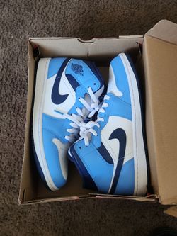 Air Jordan 1s in the Obsidian colorway.