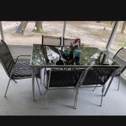 patio set, glass table and six chairs with cushions included