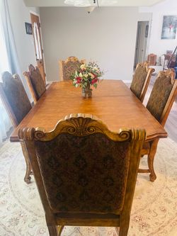 Traditional solid wood dining set a double-pedestal trestle table with matching 6 upholstered high-back chairs.