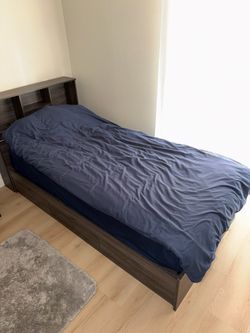 Twin beds with mattresses and dresser