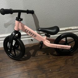 Pink toddler balance bike