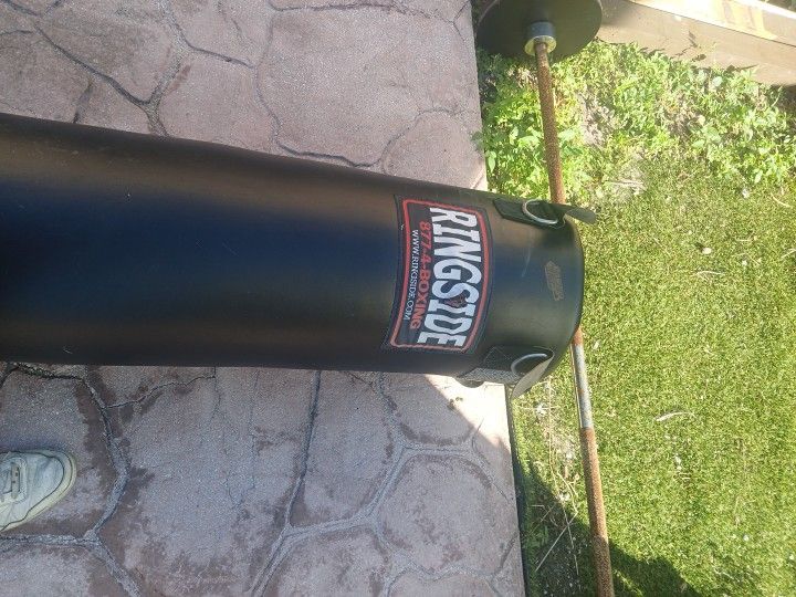 100 Pnd Punching Bag And Two 25 Pnd Plates And Solid Bar