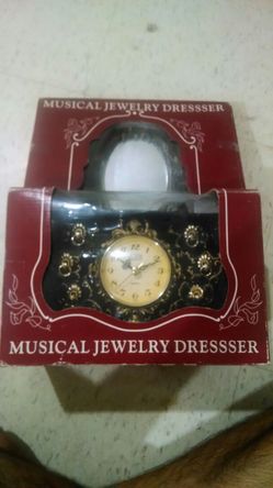 Musical jewelry dresser with clock