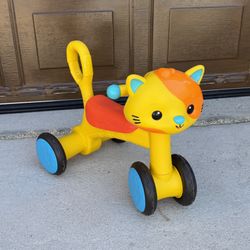  B. play Riding Buddy Cat Ride-On Toy. 