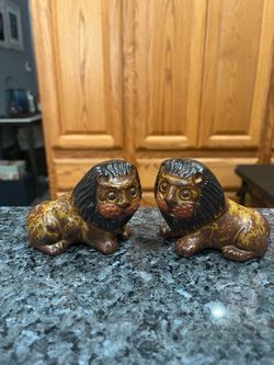 Vintage Red Clay Lion Pair of Salt and Pepper Shakers. Size approximately 3 1/2 inches wide and 3 inches tall. Preowned never used. Has been on dis