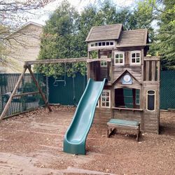 Outdoor Playhouse With A Swing Set