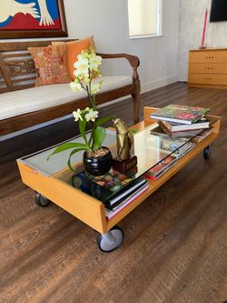 For sale italian coffee table—crafted from cherry wood, glass, metal tray and wheels.