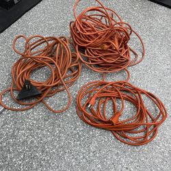 Extension cords, orange, 100 ft, 44 ft, and 30 ft.  All sold together.