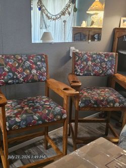 2 solid oak/billiard material covered bar chairs with side cue holders. Paid $300 dollars each chair. Good condition. Sell for $100 each