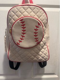 This is a Luv Betsey by Betsey Johnson white quilted baseball backpack featuring red stitching and piping.