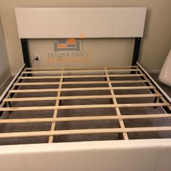 Brand new king size white faux leather platform bed frame. 
