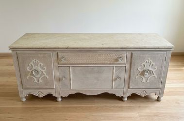 Ornate wooden dresser with stone top