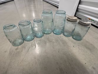 Lot of 7 antique teal mason jars. Multiple sizes, 2 with original lids