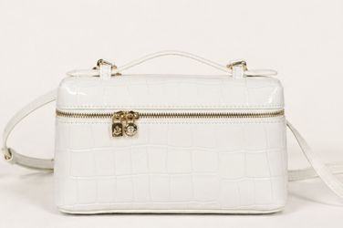 Stylish mini crossbody bag with crocodile pattern design.