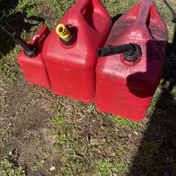 Three Gas Containers And Three Plastic Sprayers