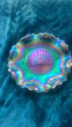 This is an Indiana Glass Windsor blue carnival glass plate with a ruffled edge.