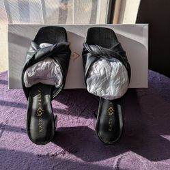 Katy Perry The Tooliped Twisted Sandal in black faux leather. 