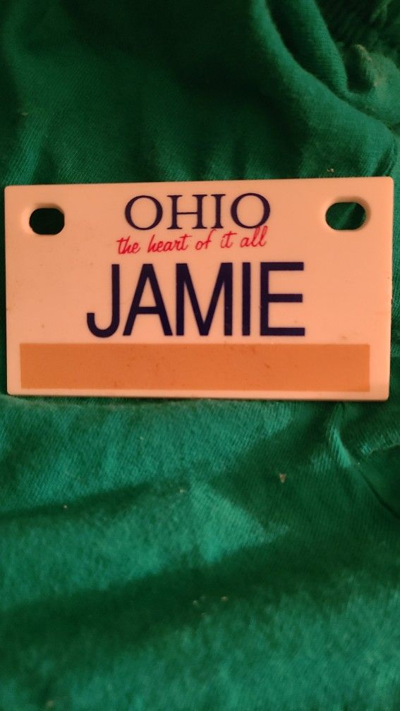 Small plastic license plate "JAMIE" on it. 4x6