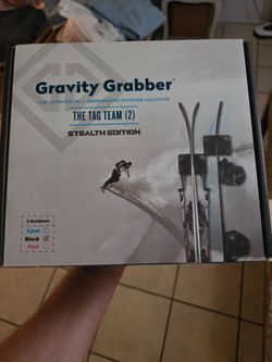 Gravity Grabber (The Tag Team - 2 Pack) Stealth Edition, which is a wall-mounted ski and snowboard storage rack.