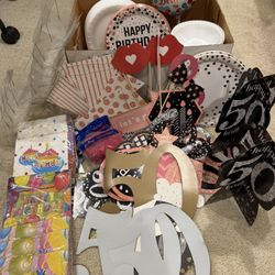 box full of party supplies decorations 