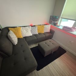 Gray sectional couch with ottoman